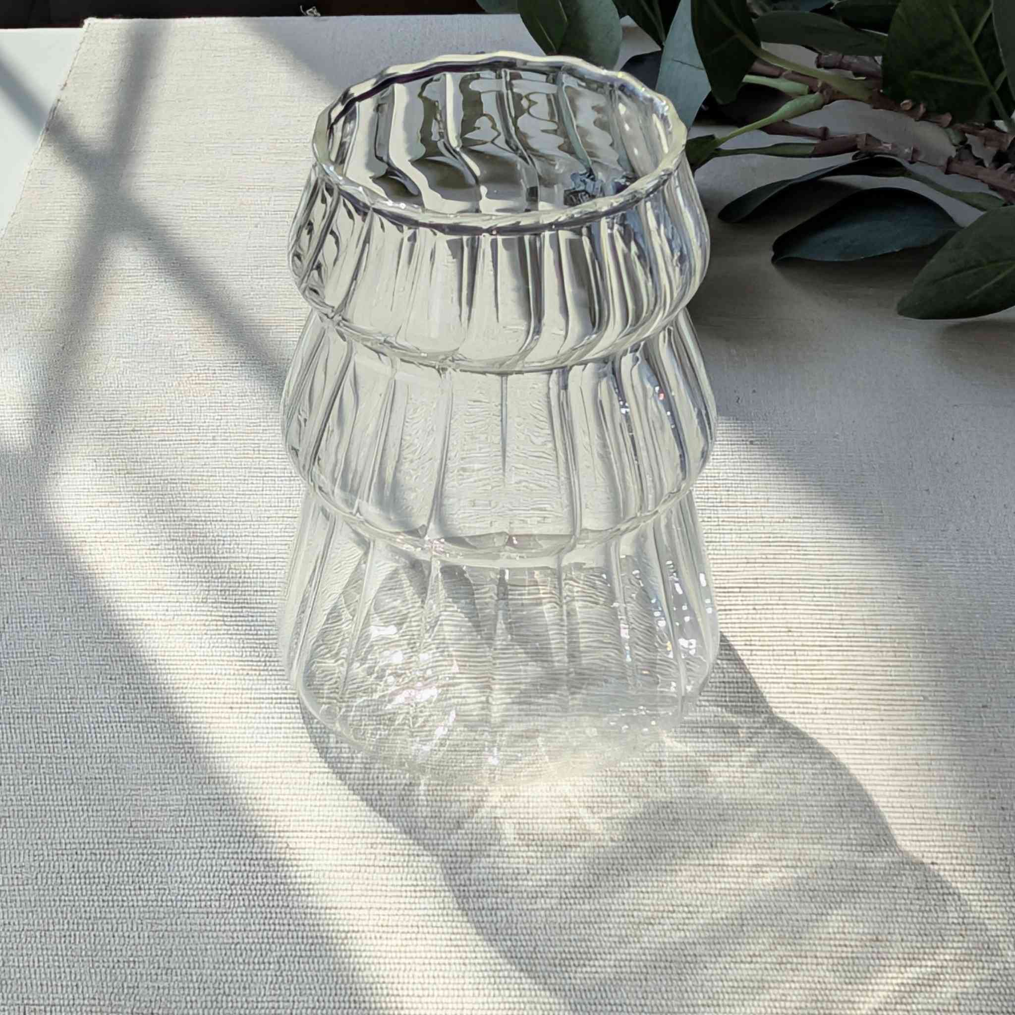 Clear Christmas tree shaped drinking glass with rippled texture, festive holiday glassware for cocktails, water, or seasonal drinks
