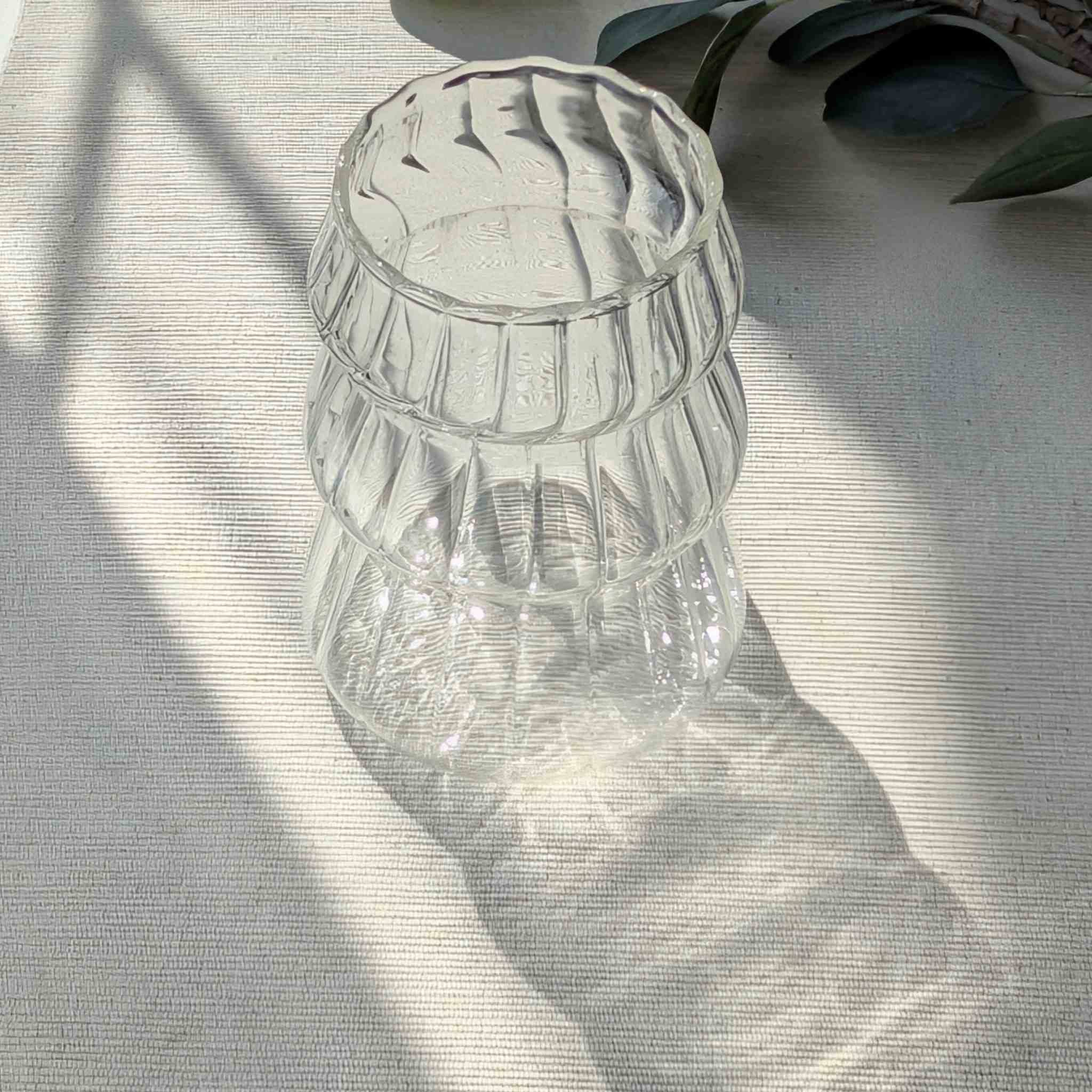 Clear Christmas tree shaped drinking glass with rippled texture, festive holiday glassware for cocktails, water, or seasonal drinks