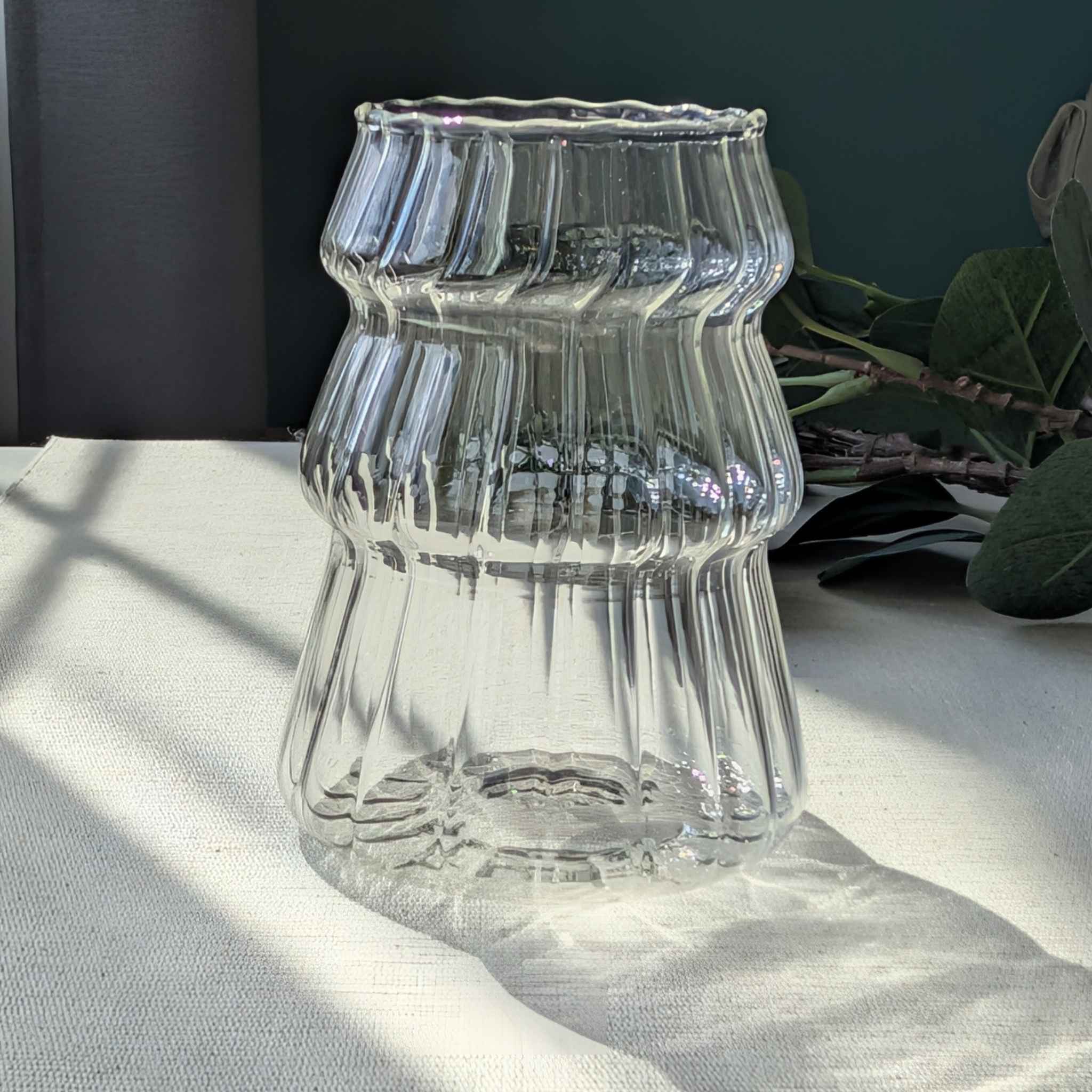 Clear Christmas tree shaped drinking glass with rippled texture, festive holiday glassware for cocktails, water, or seasonal drinks