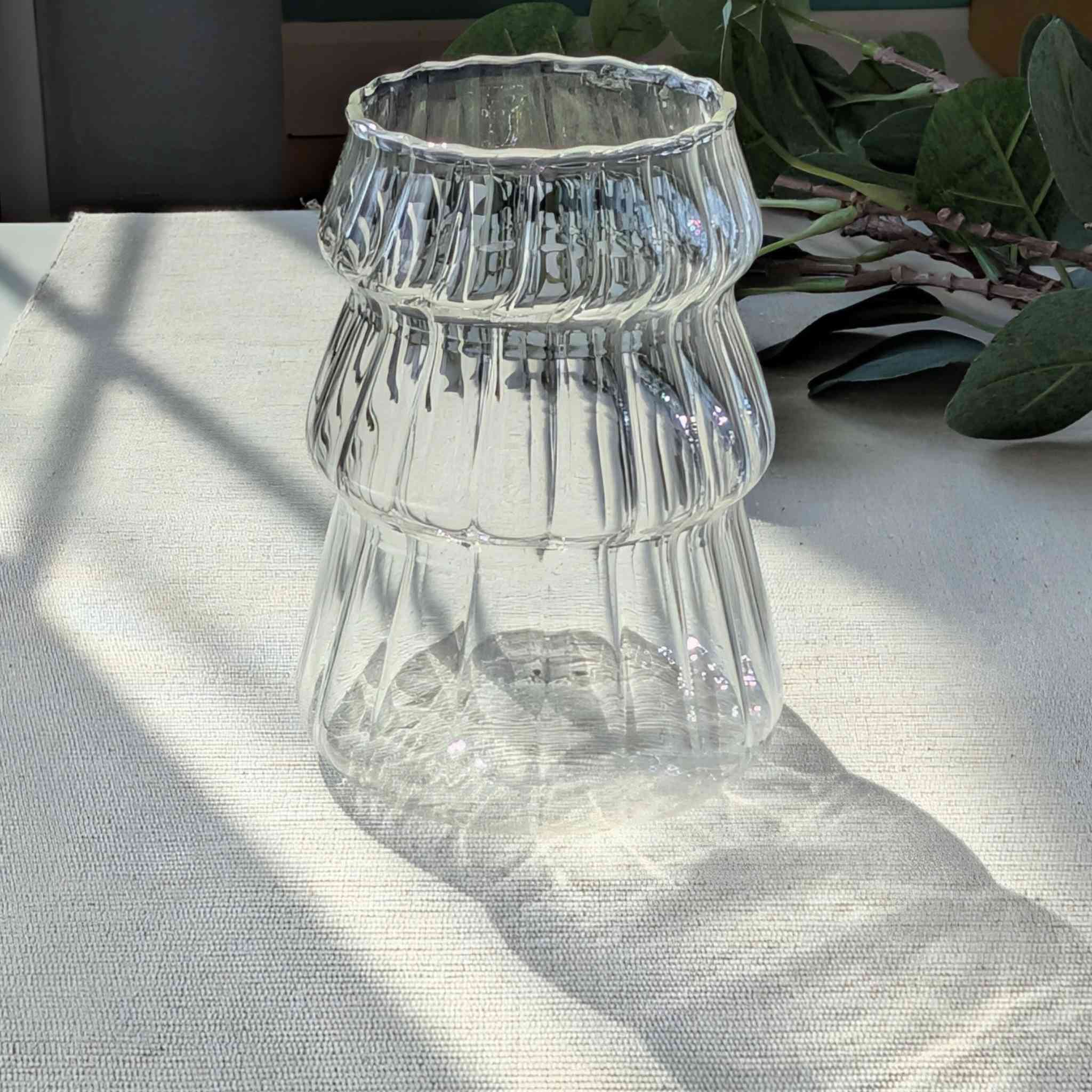 Clear Christmas tree shaped drinking glass with rippled texture, festive holiday glassware for cocktails, water, or seasonal drinks