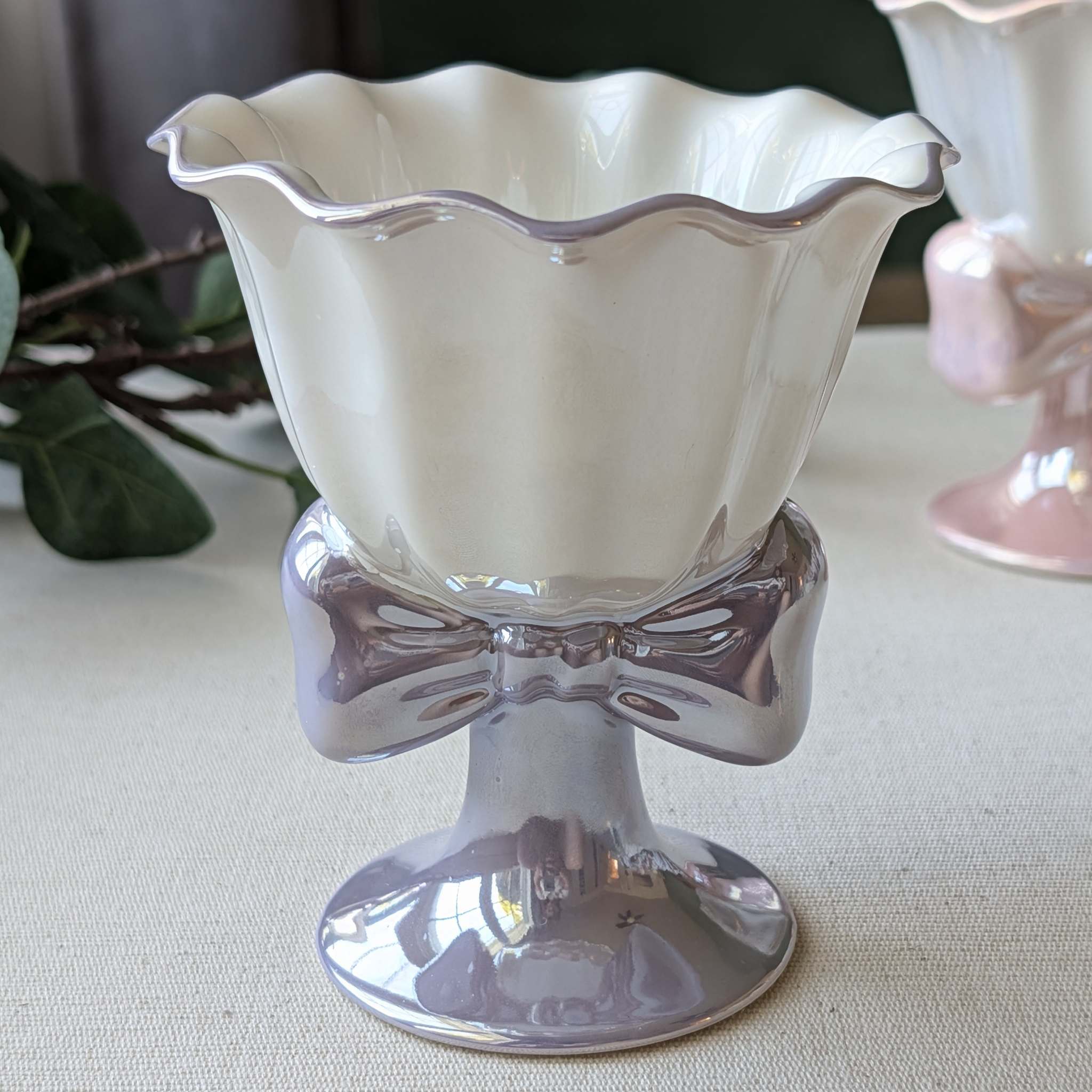 Elegant ceramic dessert cup with scalloped rim and bow-shaped base in purple