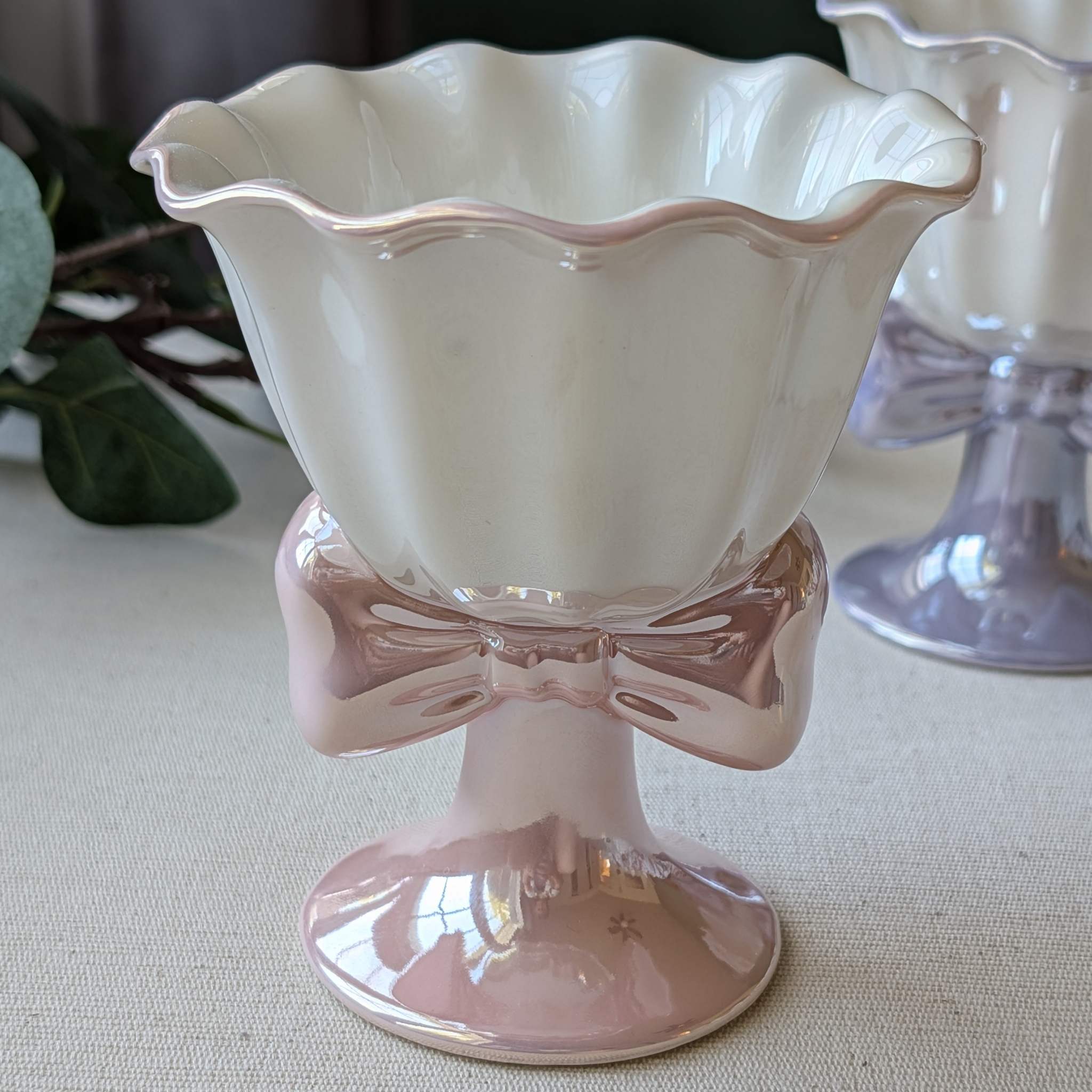 Elegant ceramic dessert cup with scalloped rim and bow-shaped base in pink