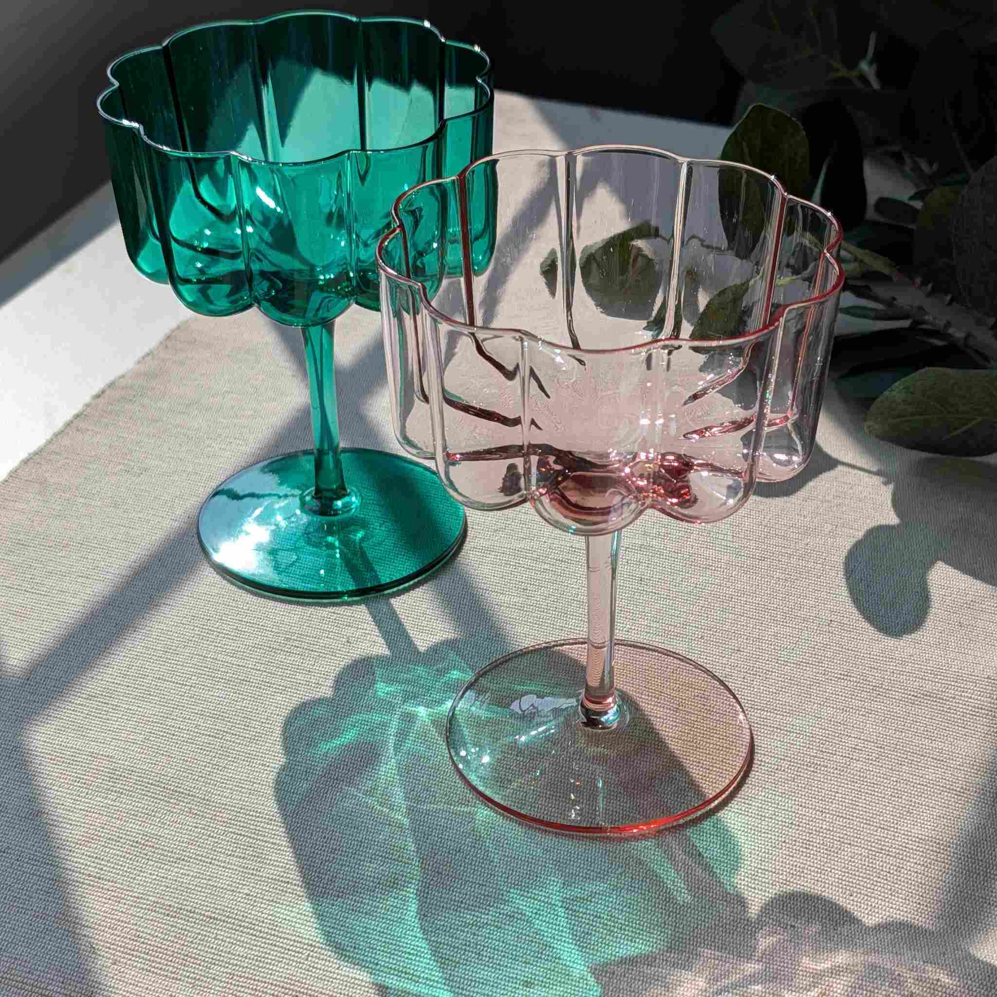 Set of flower petal cocktail, dessert, and wine glasses in green and pink, elegant stemware with scalloped design