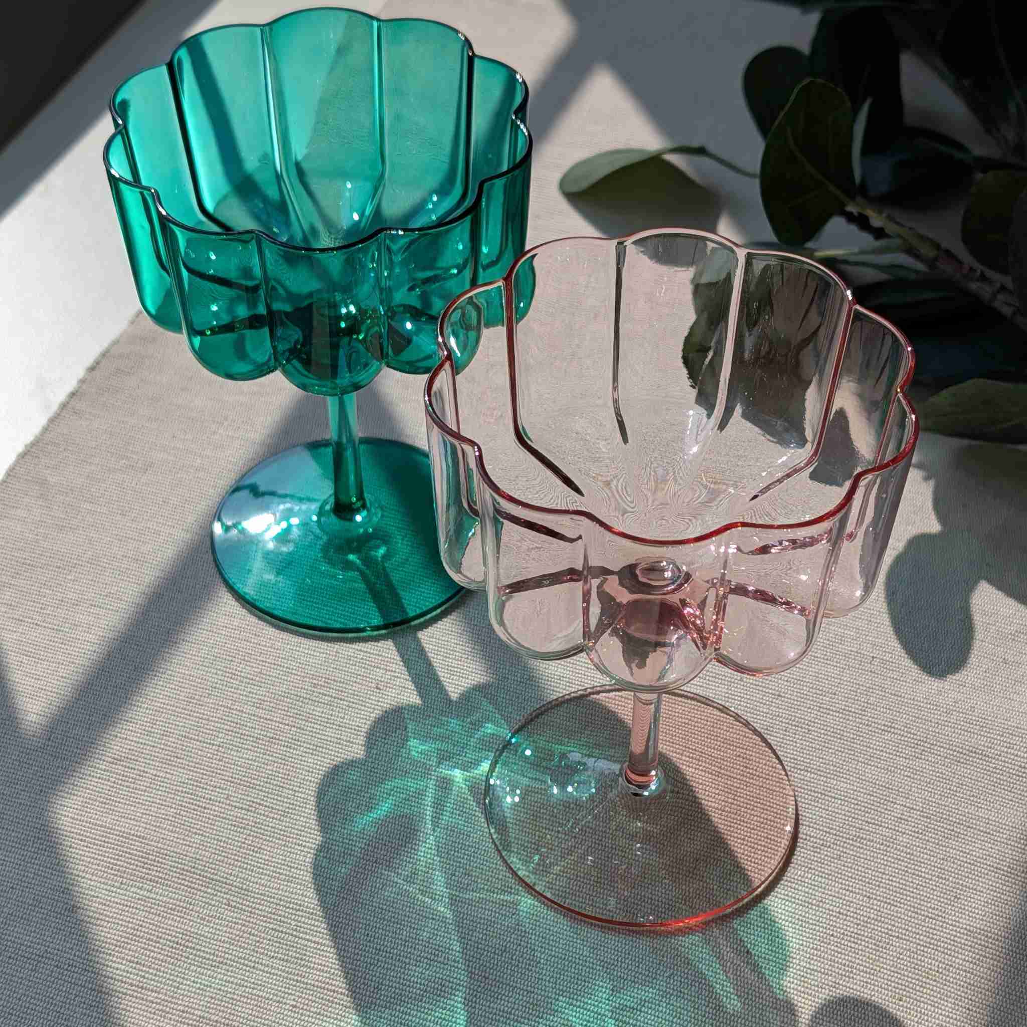 Set of flower petal cocktail, dessert, and wine glasses in green and pink, elegant stemware with scalloped design