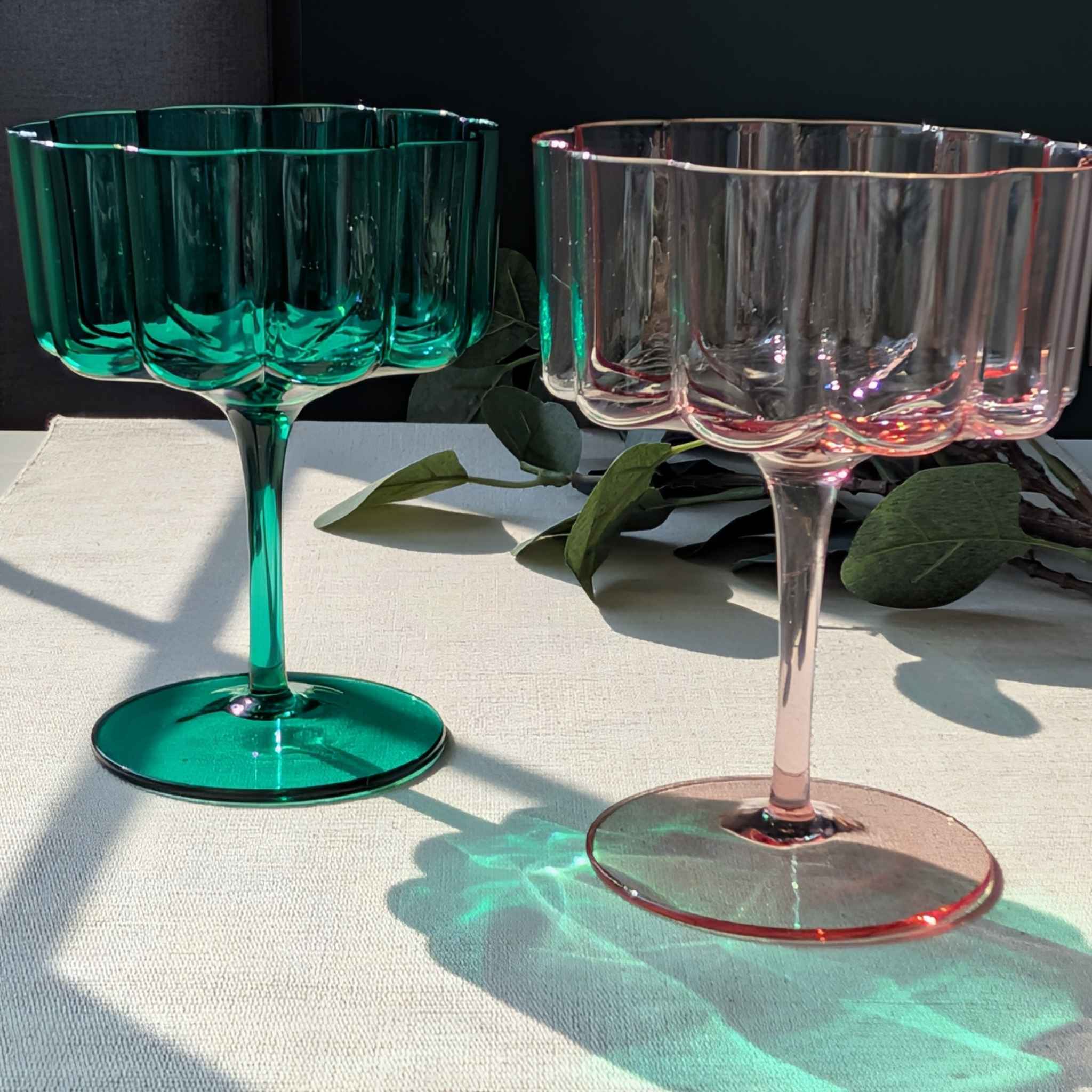 Set of flower petal cocktail, dessert, and wine glasses in green and pink, elegant stemware with scalloped design
