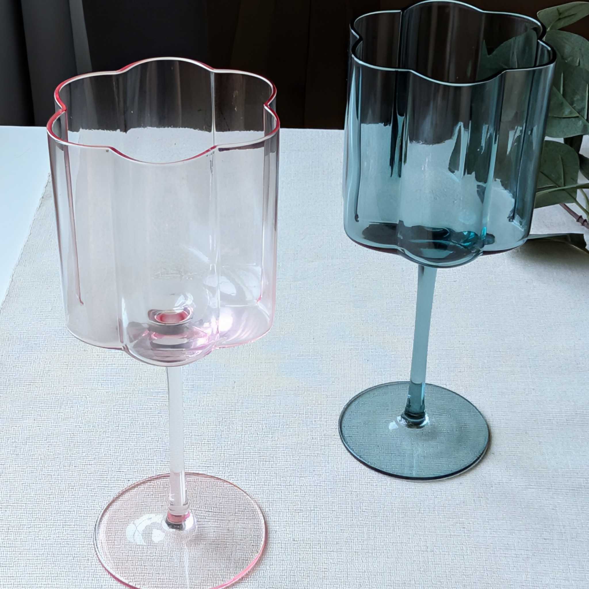 Set of tall flower-shaped scalloped wine glasses in pink and blue glass, perfect for cocktails, wine
