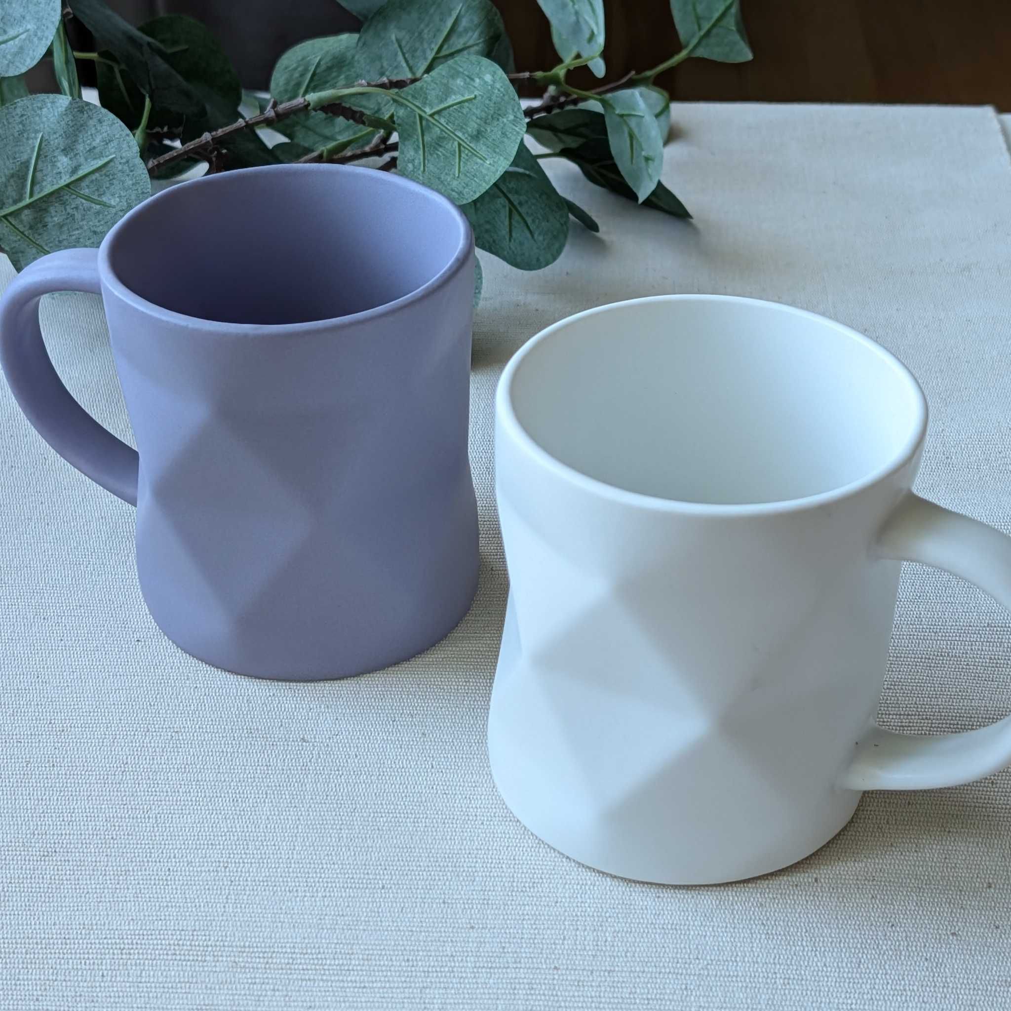 Set of modern geometric ceramic mugs in matte lavender and white