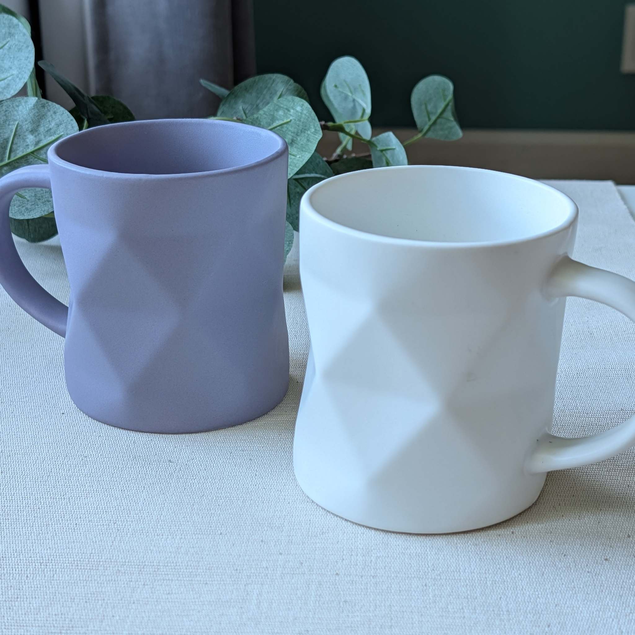 Set of modern geometric ceramic mugs in matte lavender and white