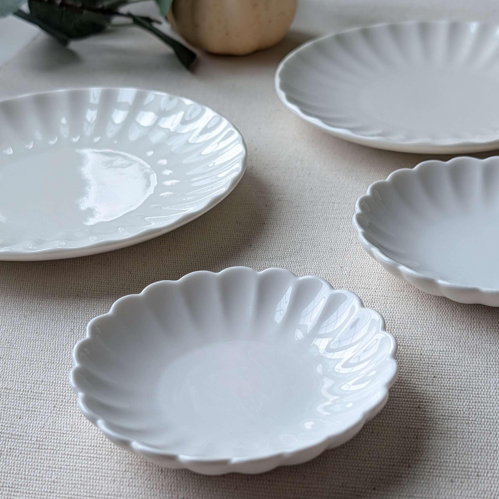 Set of ivory scalloped ceramic plates for dessert and appetizer