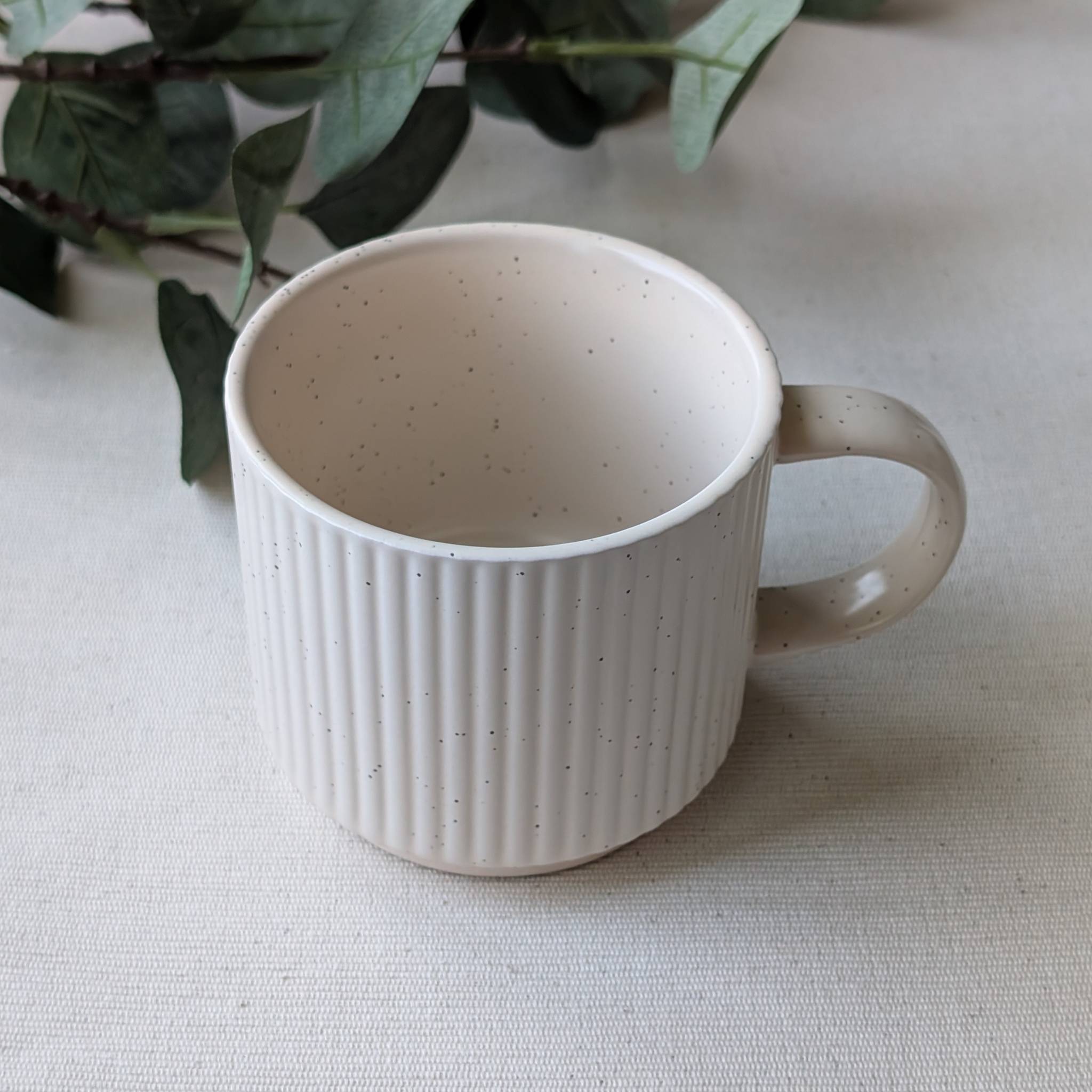 Minimalist cream speckled ceramic mug with modern handmade design