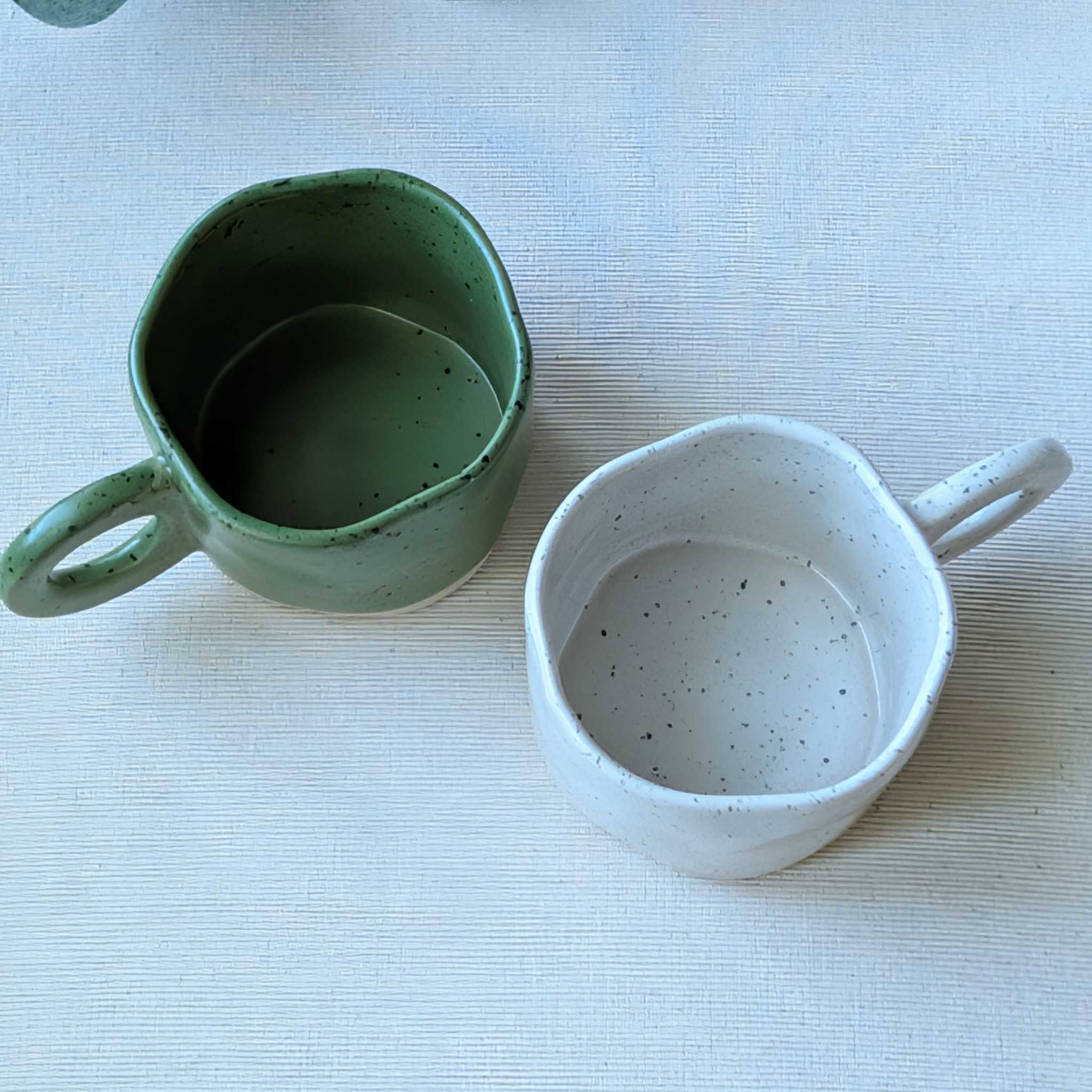Speckled ceramic mugs in green and white
