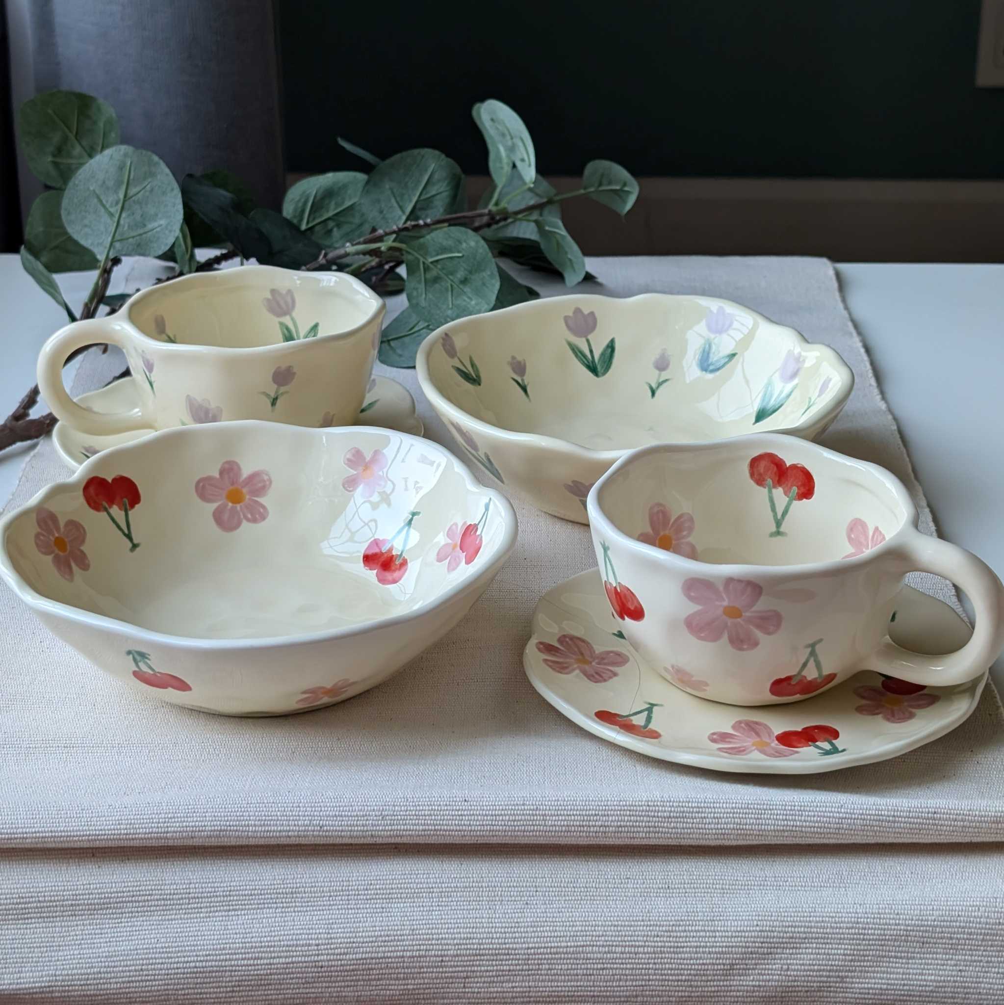 Set of wavy ceramic dishes with floral and cherry designs