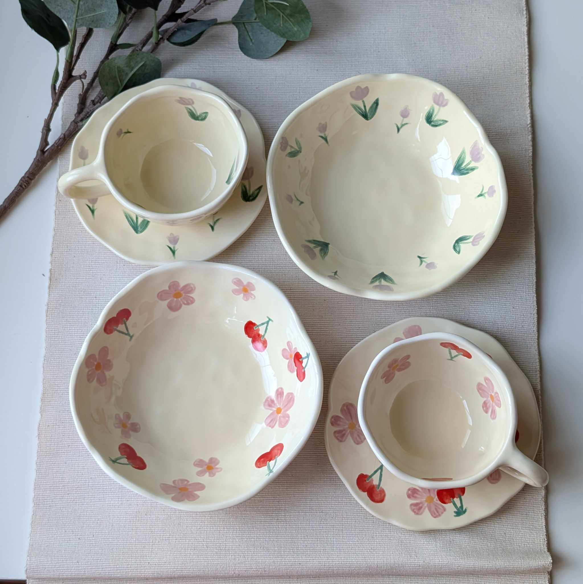 Set of wavy ceramic dishes with floral and cherry designs