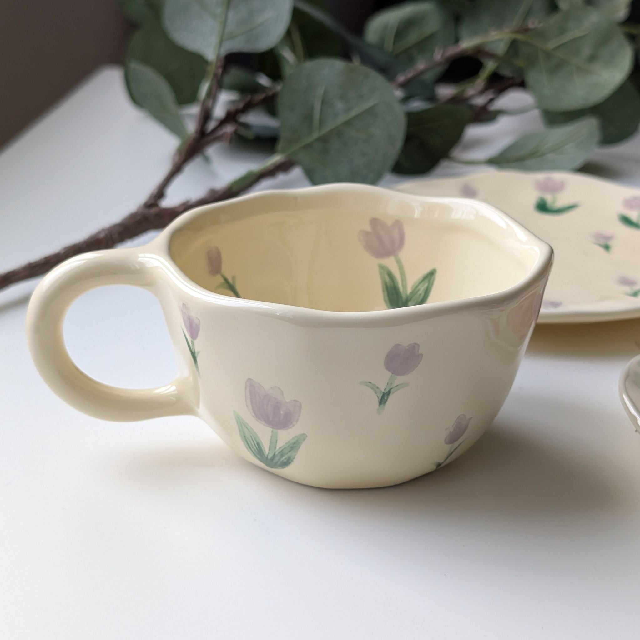 Wavy yellow ceramic cup with lavender tulips design