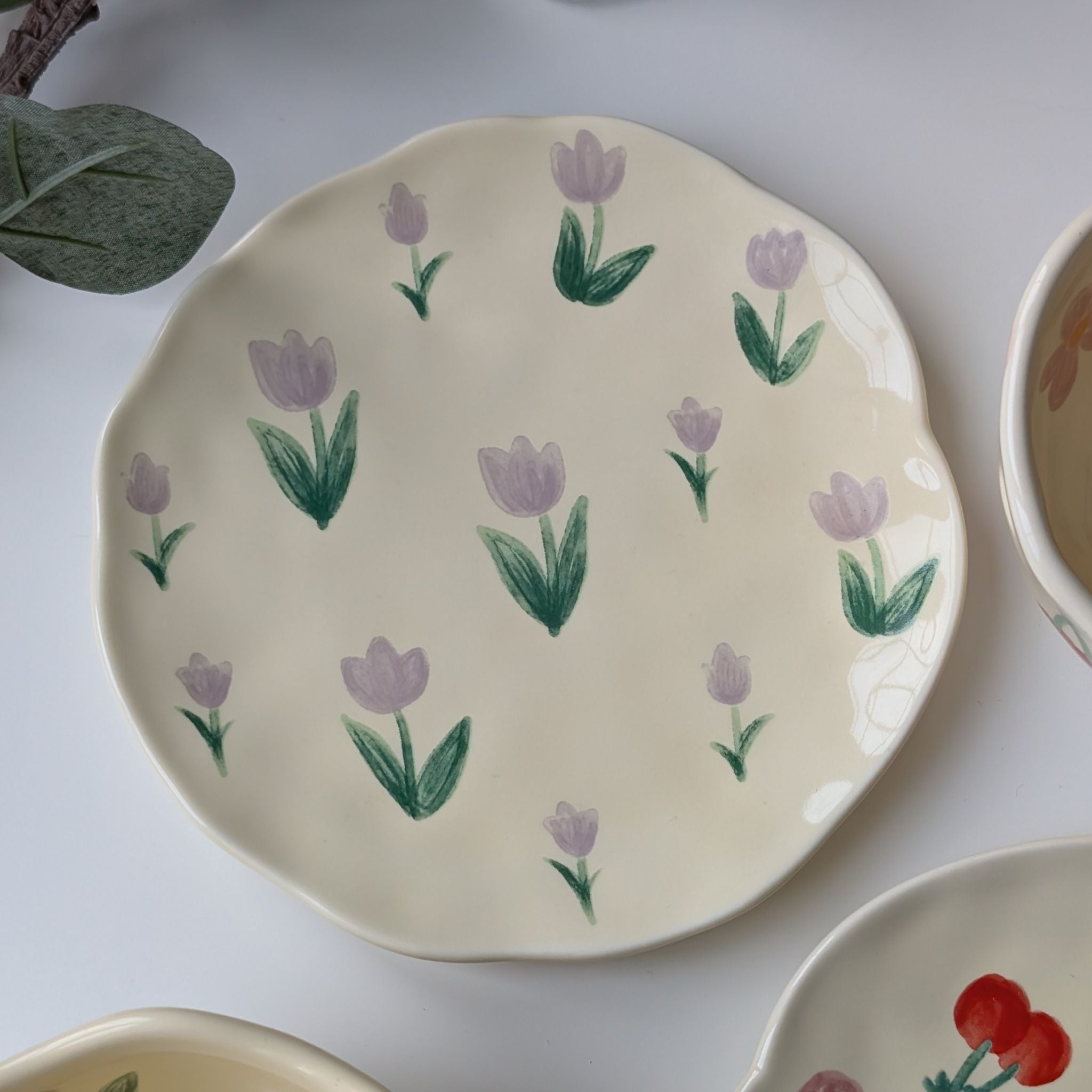 Wavy yellow ceramic plate with lavender tulips design