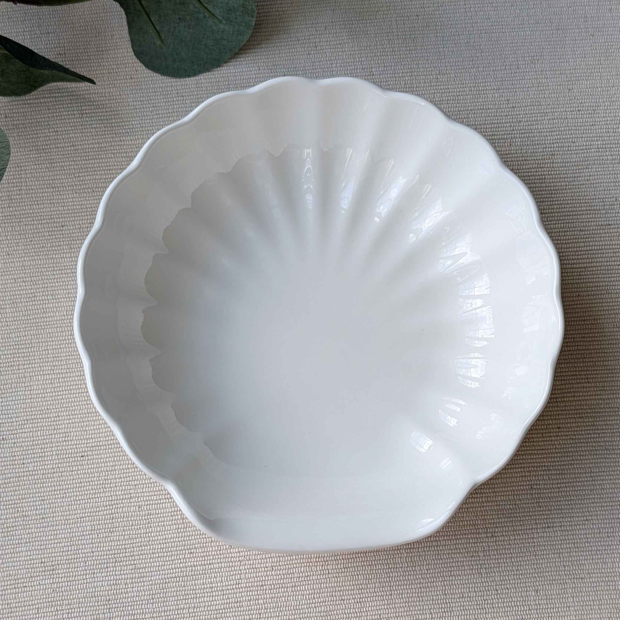 Elegant white scalloped ceramic bowl with a vintage-inspired design, perfect for serving desserts, soups, or salads